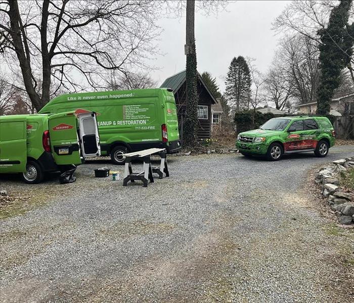 Three SERVPRO vehicles parked in a driveway