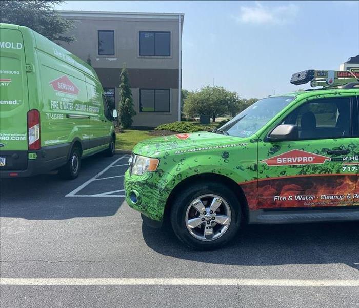 SERVPRO vehicles parked in front of a building